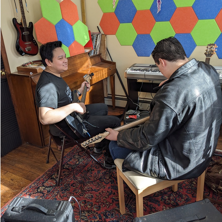 Teens playing music (bass and guitar) at RLC Connect teen social enrichment program