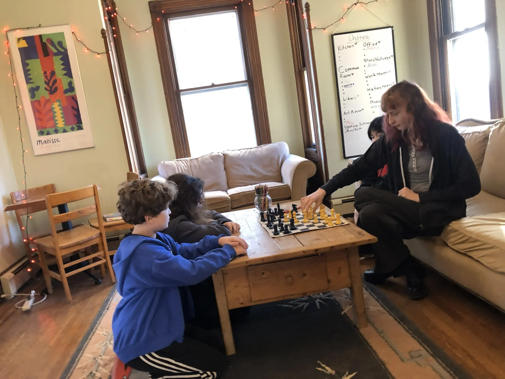Teens playing a chess game at RLC Connect teen social enrichment program